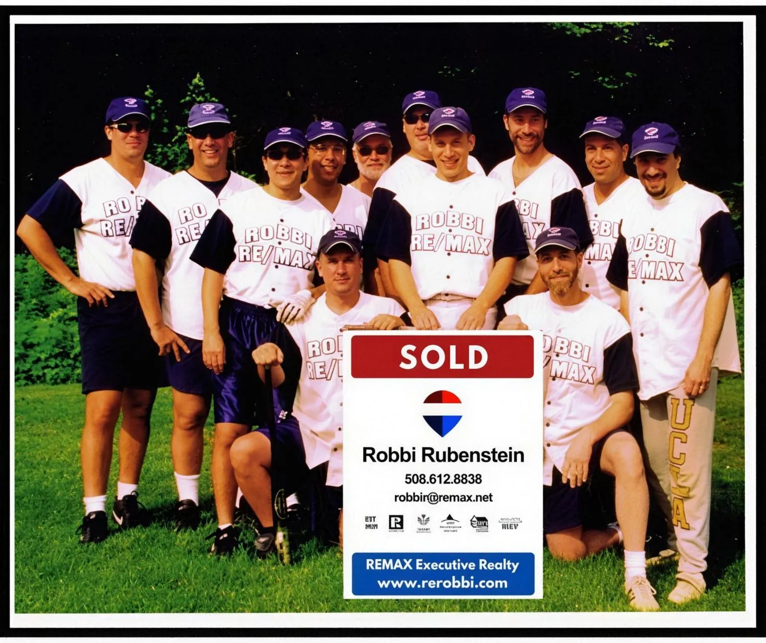 Robbi Rubenstein's REMAX team holding the SOLD sign
